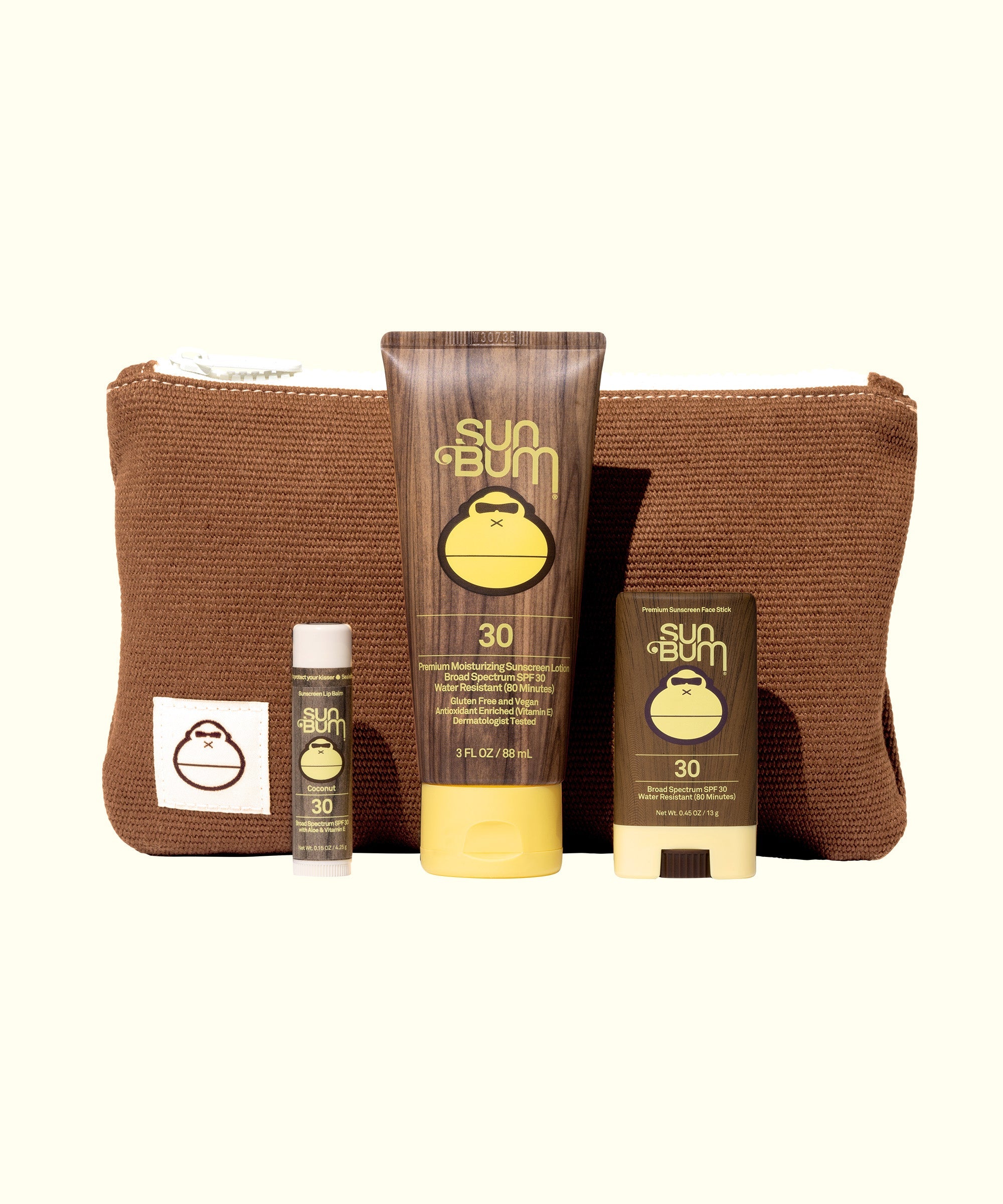 Road Tripper travel kit with SPF 30 sunscreen, lip balm and face stick in brown corduroy bag by Sun Bum