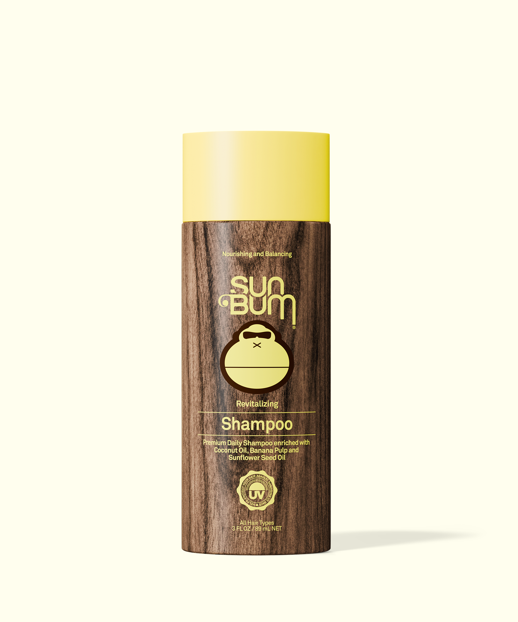 Sun Bum shampoo bottle with wooden design and yellow lid on a white background