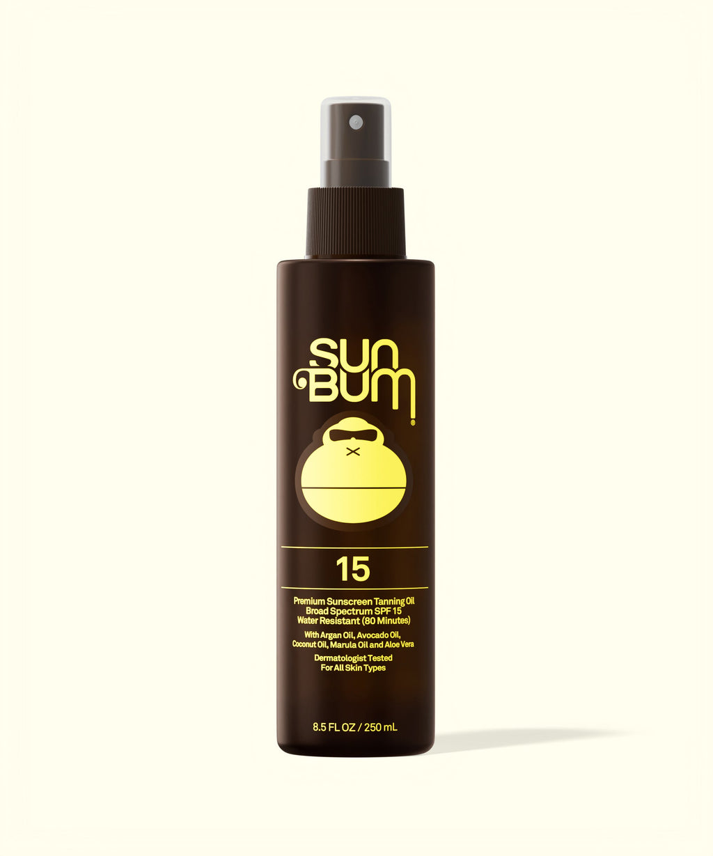 Sun Bum SPF 15 Sunscreen Tanning Oil in a brown spray bottle with yellow logo and text on white background